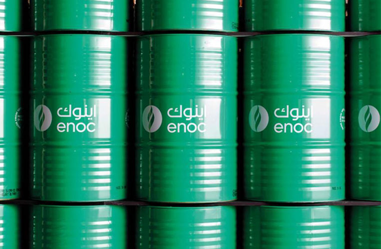 Stacked green oil barrels labeled with the ENOC logo, representing ENOC Lubricants.
