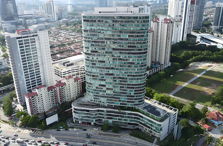 Aerial view of a modern high-rise office building in Malaysia, representing the headquarters of Oxden G&L Marketing Sdn Bhd.